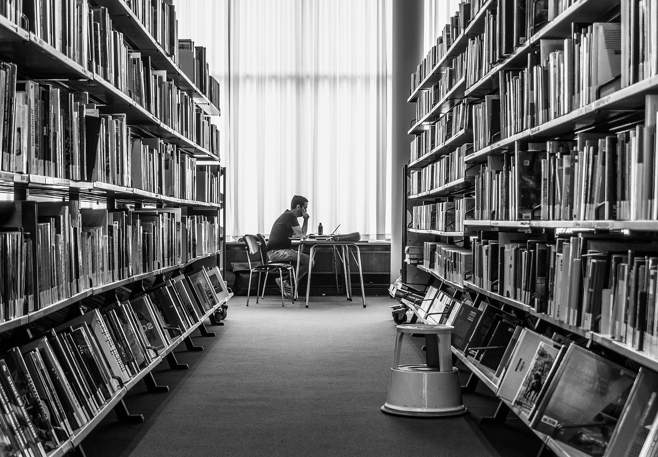 Greyscale photo of library shelves